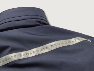 broadgate london jacket in navy with broadgate written across back of shoulders in high vis